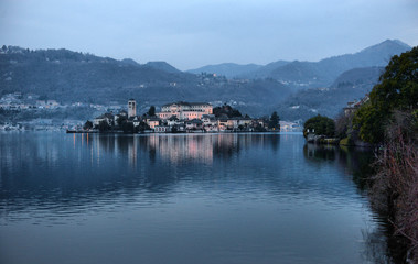 Fototapeta na wymiar Orta Lake landscape. Orta San Giulio village, island Isola S.Giulio and Alps mountains view,