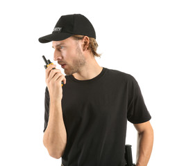 Male security guard with portable radio transmitter on white background