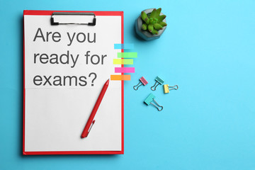 Clipboard with text ARE YOU READY FOR EXAMS? on color background