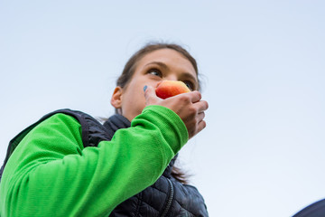 Athletic woman having a healthy fruit snack during outdoor exercise.