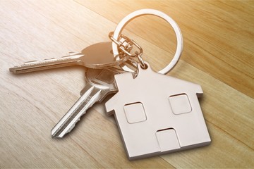 House keys with house figure  on background