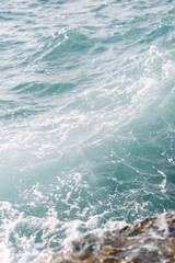 Sea in Cyprus at sunset. Beautiful spray and blue water.