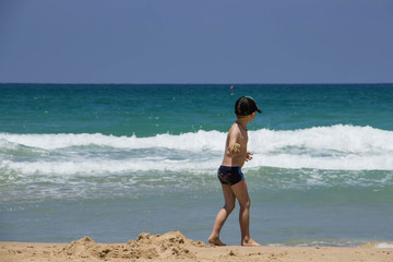 The guy is resting on the beach at the blue sea tender