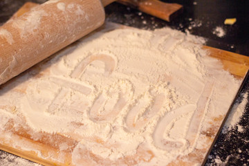 The inscription on the flour. Flour on the board. Food.