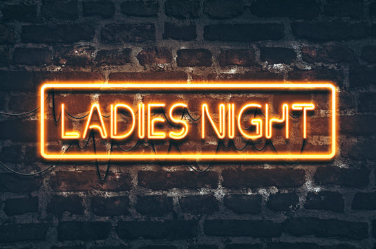 Ladies night neon sign on dark brick wall