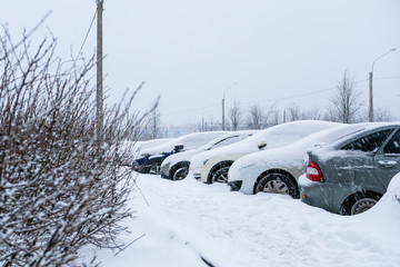cars under snow. snowfall in the city