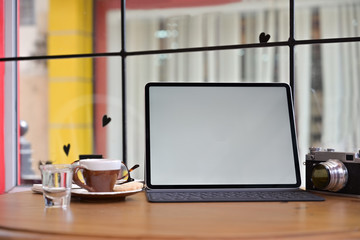 Creative photographer desk with mockup blank screen tablet and vintage camera