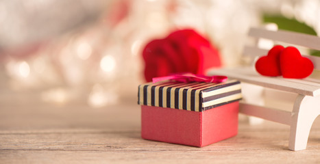 Concept of Valentine, anniversary, wedding celebration and propose, heart shapes on a white wooden bench, bokeh background, closeup