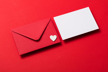 Valentine's day love letter mockup. Red envelope blank white card and hearts