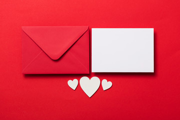 Valentine's day love letter mockup. Red envelope blank white card and hearts