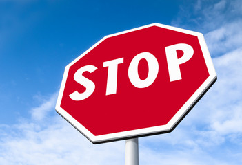 Stop sign against blue sky