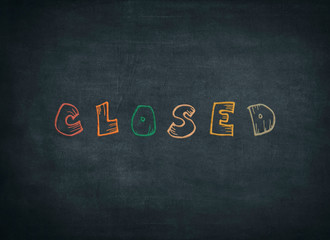 Closed sign written by color chalk on blackboard © Francesco 