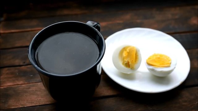 boiled chicken eggs on a plate on a wooden table
