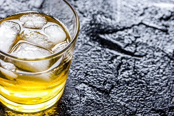 glass of whiskey on dark background