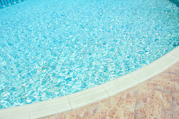 Fototapeta na wymiar Beautiful swimming pool at the seaside hotel in park background