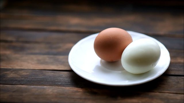 boiled chicken eggs on a plate on a wooden table