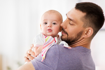 family, parenthood and people concept - father with little baby girl at home