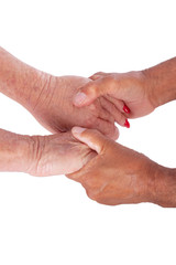 Closeup of mature caucasian man and woman holding hands isolated on white background. Metaphor for new or old love, friendship and acceptance. Inspiration for Valentine's Day poster and meme.