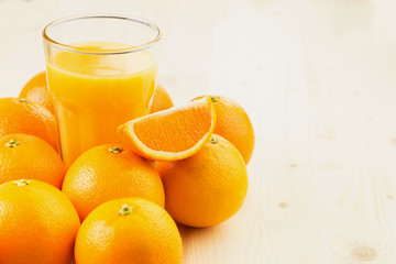 Glass of freshly pressed orange juice with oranges
