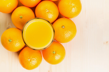 Glass of freshly pressed orange juice with oranges