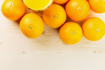 Glass of freshly pressed orange juice with oranges