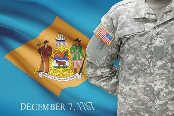 American soldier with US state flag on background - Delaware