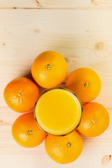 Glass of freshly pressed orange juice with oranges