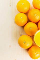 Glass of freshly pressed orange juice with oranges