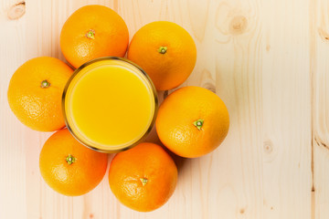 Glass of freshly pressed orange juice with oranges