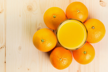 Glass of freshly pressed orange juice with oranges