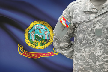 American soldier with US state flag on background - Idaho