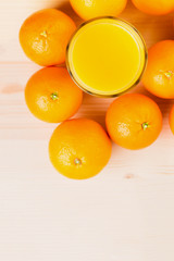 Glass of freshly pressed orange juice with oranges