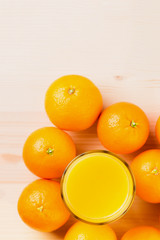 Glass of freshly pressed orange juice with oranges