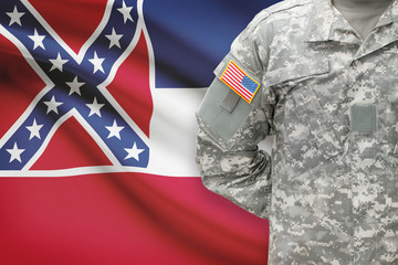 American soldier with US state flag on background - Mississippi