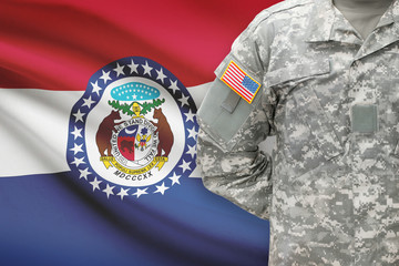 American soldier with US state flag on background - Missouri