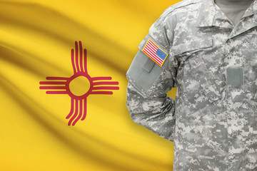 American soldier with US state flag on background - New Mexico