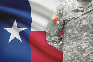 American soldier with US state flag on background - Texas