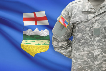 American soldier with Canadian province flag on background - Alberta