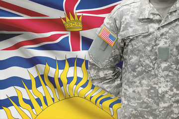 American soldier with Canadian province flag on background - British Columbia