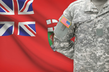 American soldier with Canadian province flag on background - Manitoba