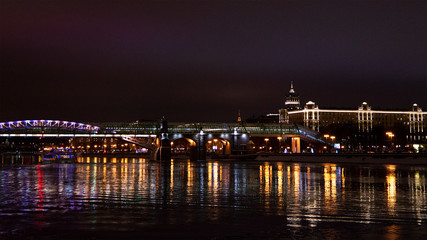 Fototapeta na wymiar Night view of Pushkinskiy bridge over Moskva river with lights reflected in water, Moscow, Russia