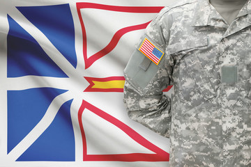 American soldier with Canadian province flag on background - Newfoundland and Labrador