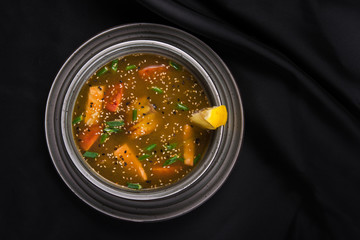 Asian spicy soup with lemon, eel and tomato