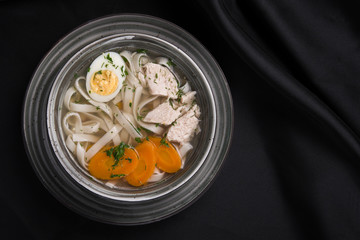chicken soup with egg, carrot and noodles