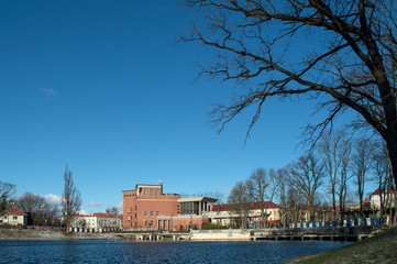 Winter landscape sunny afternoon house on the lake on a blue background
