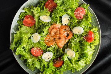 Fresh salad with shrimp, egg and mixed greens