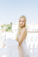 Bright morning bride in a Villa in Cyprus. Beautiful girl in a white boudoir dress.