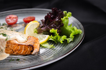Fish steak salmon grilled with fresh salad