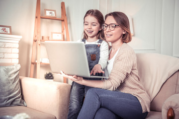 Positive smart nice woman holding a laptop