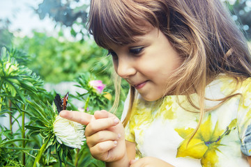 child with a butterfly in his hands. Selective focus.